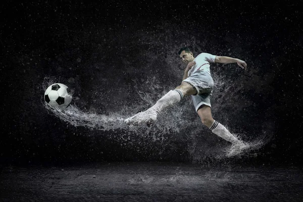 Splash of drops around football player — Stock Photo, Image