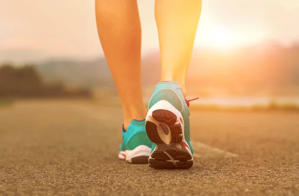 Runner athlete feet running on road — Stock Photo, Image