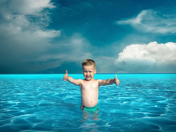 Niño en agua bajo la luz del sol —  Fotos de Stock