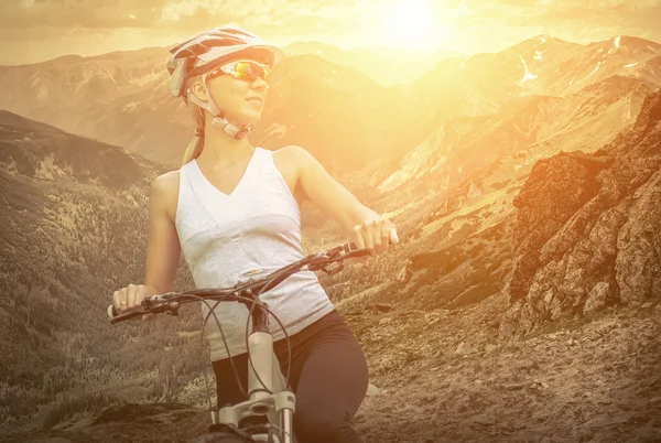 Woman in helmet  on the bicycle — Stock Photo, Image