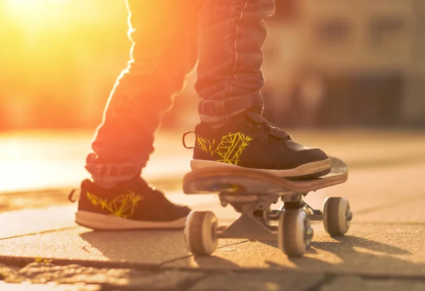 Child with skateboard on the street — Stock Photo, Image