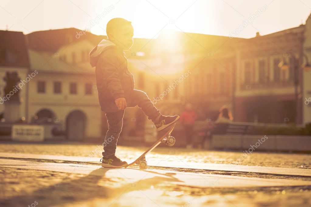 Child with skateboard on the street
