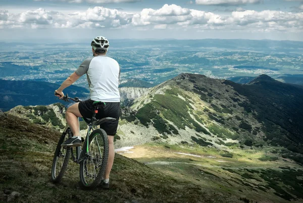 Mann mit Fahrrad in den Bergen — Stockfoto