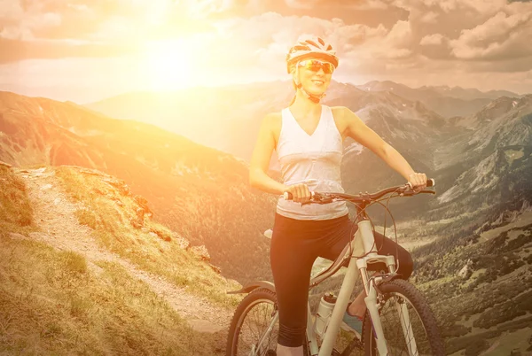 Woman in helmet  on the bicycle — Stock Photo, Image