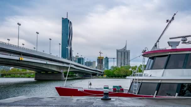 VIENNA, AUSTRIA - MAY 05, 2021: Time-lapse on the Danube river with ships and the DC tower in the background in Wien, Vienna, Austria on a cloudy day. — Stock Video