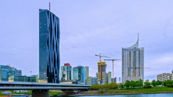 VIENNA, AUSTRIA - MAY 05, 2021: Time-lapse on the Danube river with ships and the DC tower in the background in Wien, Vienna, Austria on a cloudy day. — Stock Video