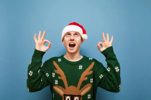 Joven Sorprendido Con Sombrero Santa Suéter Navidad Está Pie Sobre —  Fotos de Stock
