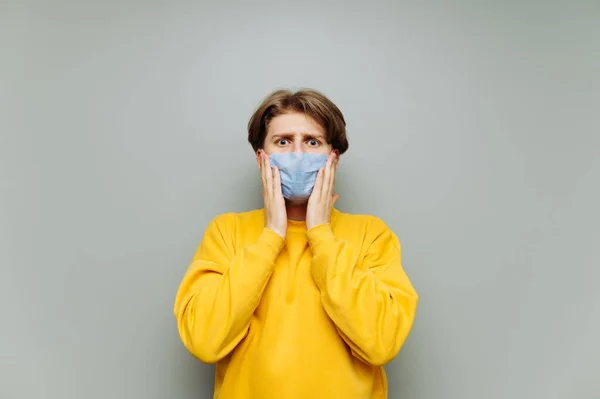 Young Man Medical Mask His Face Looks Camera Points His — Stock Photo, Image