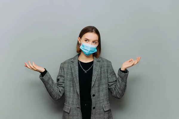 Puzzled Business Woman Suit Medical Mask Face Isolated Gray Background — Stock Photo, Image