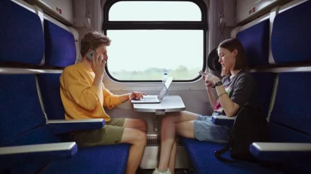 Egy Pár Modern Fiatal Egy Asztalnál Egy Vonatfülkében Szerkentyűket Használ — Stock videók