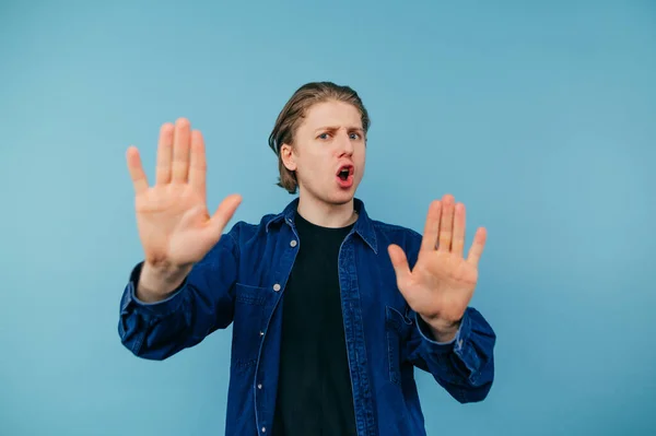 Dissatisfied Young Man Shirt Stands Blue Background Looks Camera Emotional — Foto Stock