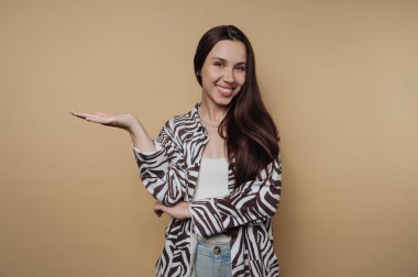 Smiling woman in zebra print jacket gesturing with open hand