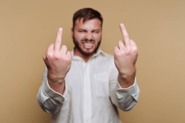 Sakallı bir adam beyaz gömlek giyer ve iki orta parmağını da şakasına gösterir. İfade veren bir yüz ifadesi takınıyor. Basit bir geçmişe karşı mizah ve başkaldırı karışımı bir ifade sergiliyor..