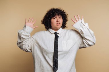 Bir insan güvenle ayakta duruyor, elleri havada, neşeli bir tutum ve sürpriz karışımı ifade ediyor..