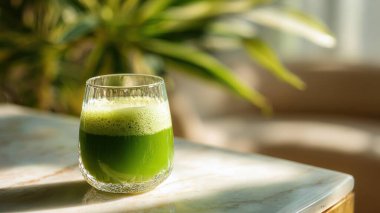 Mermer yüzey üzerinde kristal yeşil sebze suyu, yumuşak altın sabah ışığı, zarif bulanık kaplıca arka plan, temiz kopya alanı ile rafine edilmiş düzen..