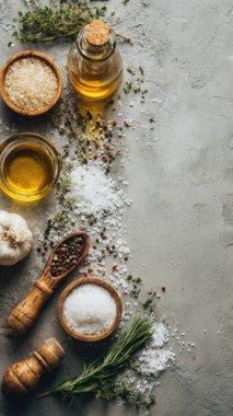 Top view flat lay of kitchen seasonings salt, pepper, oil, vinegar, and herbs on rustic countertop with copy space, warm natural light, cooking preparation concept, clean realistic style for website or print use.
