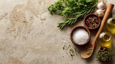 Top view flat lay of kitchen seasonings salt, pepper, oil, vinegar, and herbs on rustic countertop with copy space, warm natural light, cooking preparation concept, clean realistic style for website or print use.