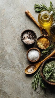 Top view flat lay of kitchen seasonings salt, pepper, oil, vinegar, and herbs on rustic countertop with copy space, warm natural light, cooking preparation concept, clean realistic style for website or print use.