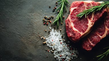 Top view flat lay of raw steak, rosemary, salt, and pepper on rustic background with copy space, soft natural light, realistic texture, cooking preparation concept, clean professional style for website or print.