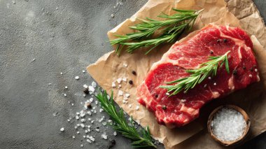 Top view flat lay of raw steak, rosemary, salt, and pepper on rustic background with copy space, soft natural light, realistic texture, cooking preparation concept, clean professional style for website or print.