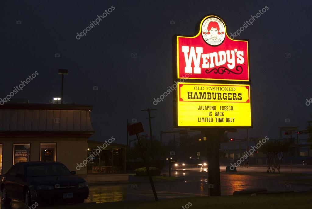 Wendy's restaurant logo illuminated at night. Wendy's is an international chain of fast food restaurants