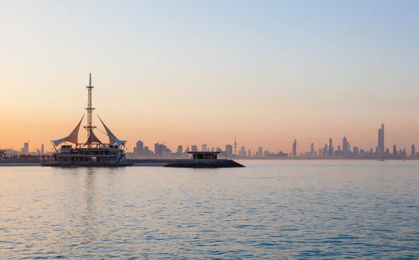 Павильон Skyline of Kuwait and Marina Waves на закате — стоковое фото