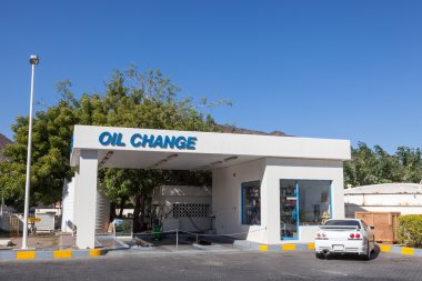 Oil Change service at a petrol station in the United Arab Emirates clipart