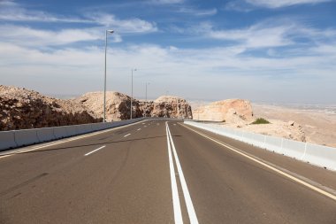 Road at the Jebel Hafeet mountain in the outskirts of Al Ain, Emirate of Abu Dhabi, UAE clipart