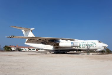 UMM AL QUWAIN, UAE - DEC 17: Old russian Ilyushin IL 76 cargo plane at the old Umm Al Quwain airfield. December 17, 2014 in Umm Al Quwain, UAE clipart