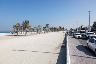 UMM AL QUWAIN, UAE - DEC 20: Beach and corniche in Umm Al Quwain. December 20, 2014 in Umm Al Quwain, UAE clipart