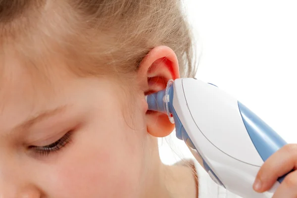 Taking temperature with ear thermometer — Stock Photo, Image