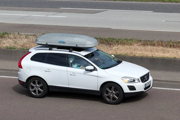 Volvo XC60 with a roof box on the highway — Stok fotoğraf