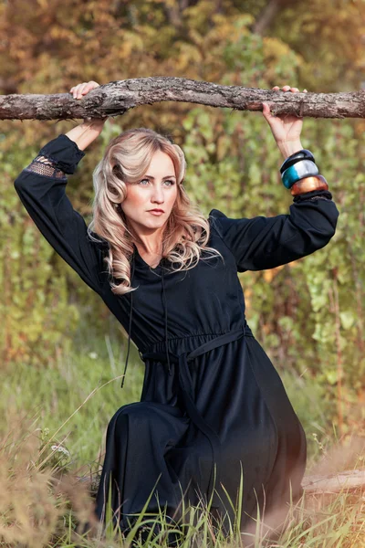 Beautiful blonde woman in black dress in summer day, outdoor — Stock Photo, Image