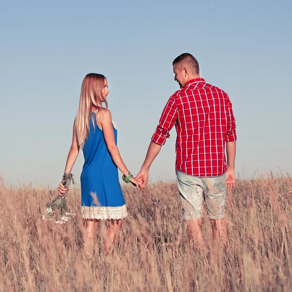 Liefdesverhaal. Mooie jonge paar wandelen in de weide, buiten — Stockfoto