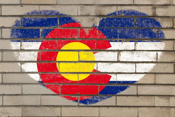 Heart shape flag of colorado on brick wall — Stock Photo, Image