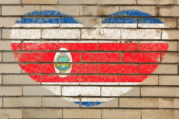 レンガの壁にコスタリカのハート形のフラグ — ストック写真