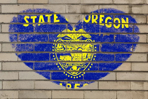 Heart shape flag of oregon on brick wall — Stock Photo, Image