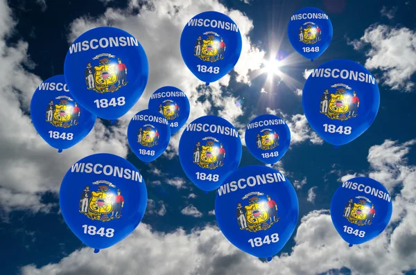 Many balloons with wisconsin flag on sky — Stock Photo, Image