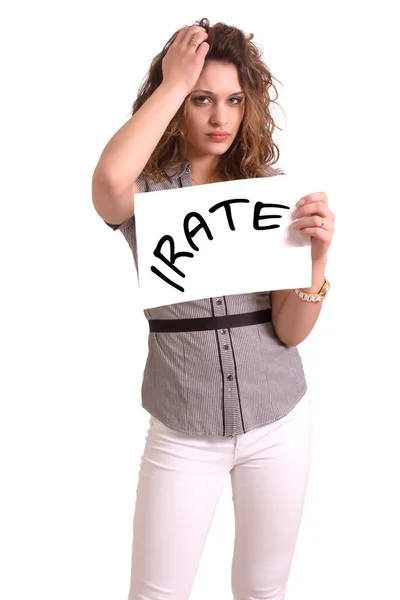 Uncomfortable woman holding paper with Irate text — Stock Photo, Image