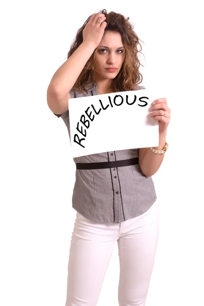 Uncomfortable woman holding paper with Rebellious text — Stock Photo, Image