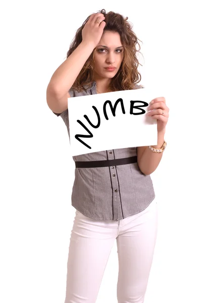 Uncomfortable woman holding paper with Numb text — Stock Photo, Image