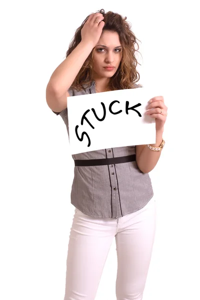 Uncomfortable woman holding paper with Stuck text — Stock Photo, Image