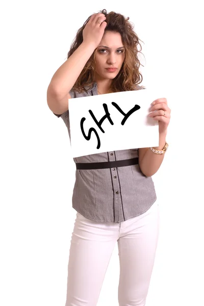 Uncomfortable woman holding paper with Shy text — Stock Photo, Image