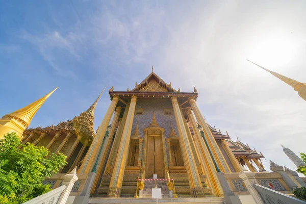 Golden pagoda at Temple of the Emerald Buddha in Bangkok, Thailand. Wat Phra Kaew and Grand palace in old town, urban city. Buddhist temple, Thai architecture. A tourist attraction