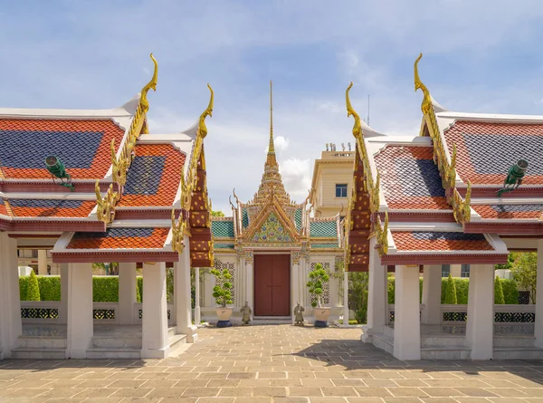 Golden pagoda at Temple of the Emerald Buddha in Bangkok, Thailand. Wat Phra Kaew and Grand palace in old town, urban city. Buddhist temple, Thai architecture. A tourist attraction