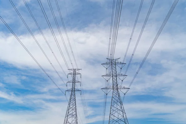 High voltage poles. Power lines on utility tower and cable wires in energy electric technology, network, and industry concept. Generator pylon. Transmission and substation.