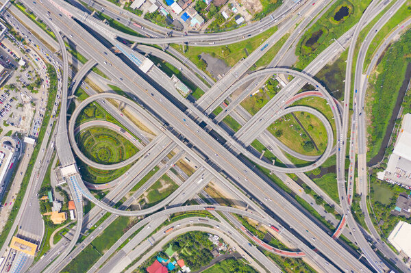 Aerial view of cars driving on highway junctions. Bridge street roads in connection network of architecture concept. Top view. Urban city, Bangkok, Thailand.