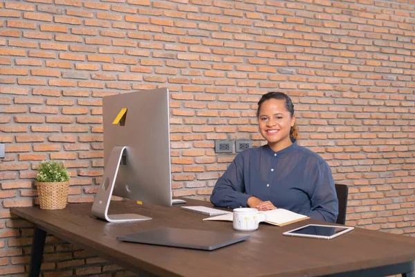 Portrait of smiling business black woman, African American person working from home with computer in technology device concept. Freelancer working online. People lifestyle.