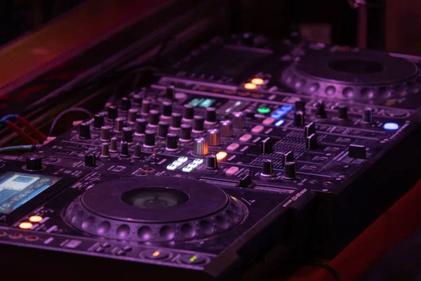 Mixes on CD players or track at nightclub during party for DJ. Nightlife of disco club in disco pub club bar background for party music dancing festival performance. Entertainment nightlife.