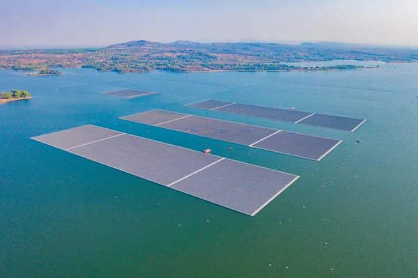 Aerial top view of solar panels or solar cells on buoy floating in lake sea or ocean. Power plant with water, renewable energy source. Eco technology for electric power in industry.